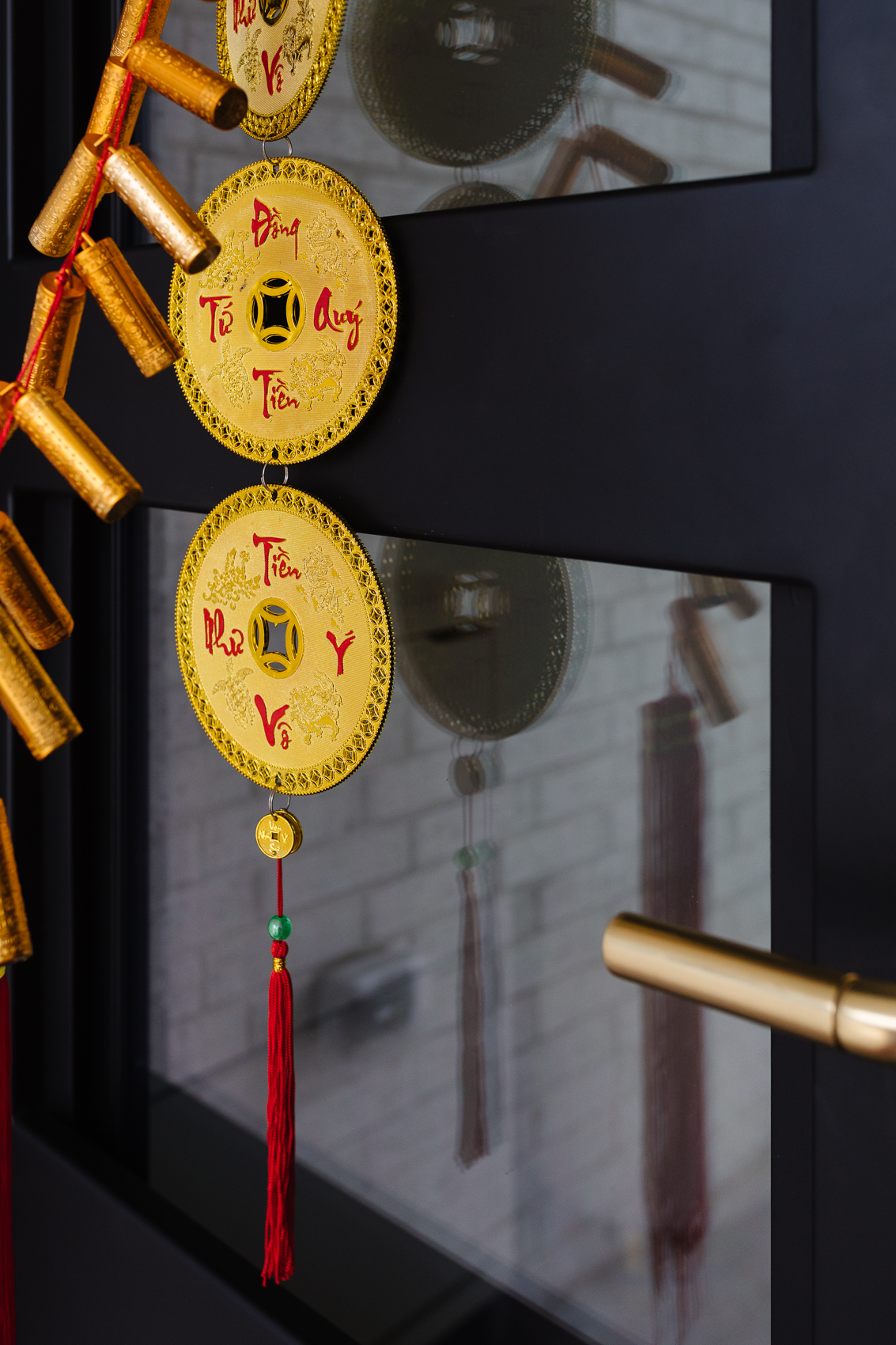 Gold coin decor and firecrackers to decorate the front door of a home for Lunar New Year or Tet Vietnamese New Year