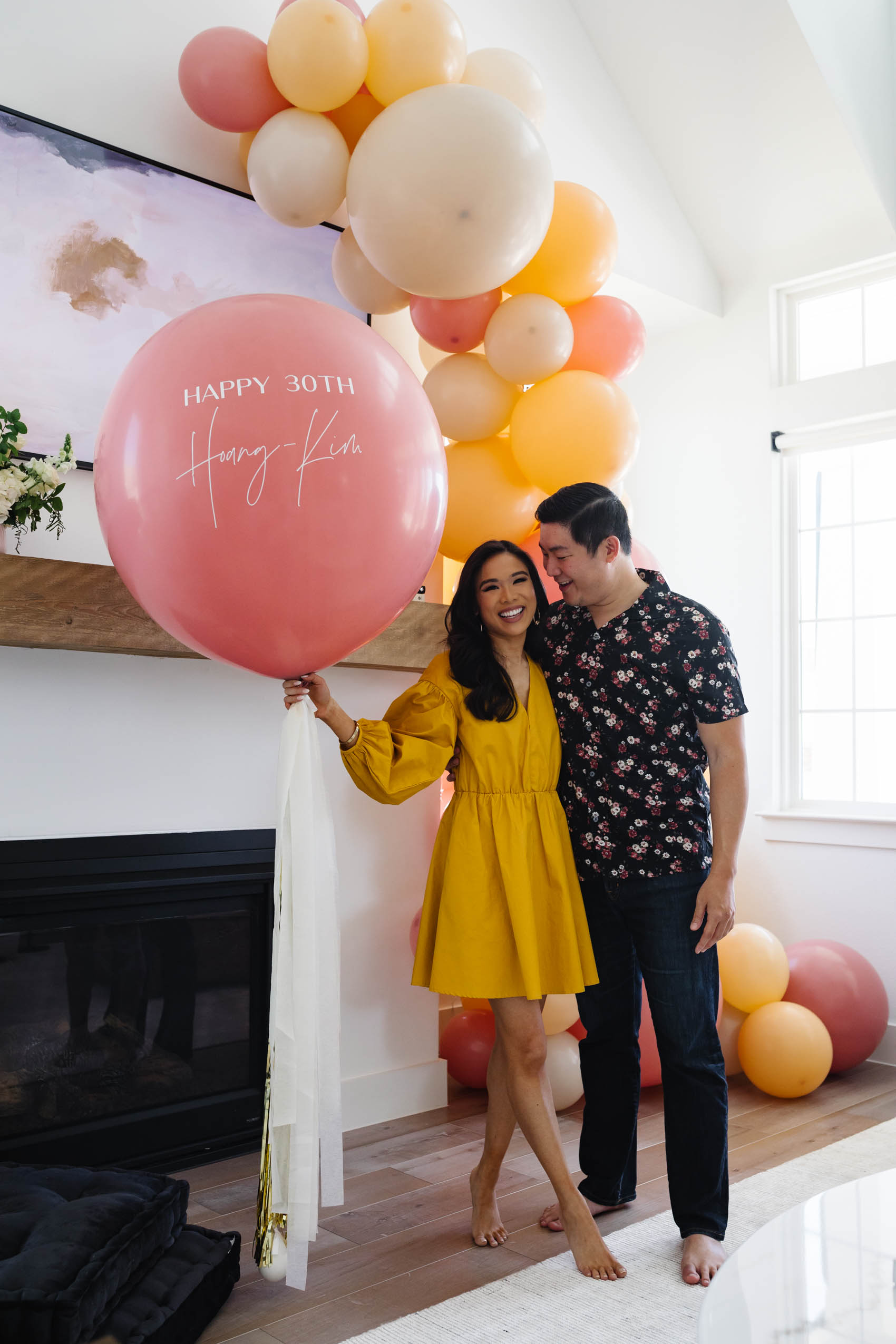Hoang-Kim and her fiance Johnny with a custom jumbo balloon and balloon garland from Lushra for her 30th Birthday