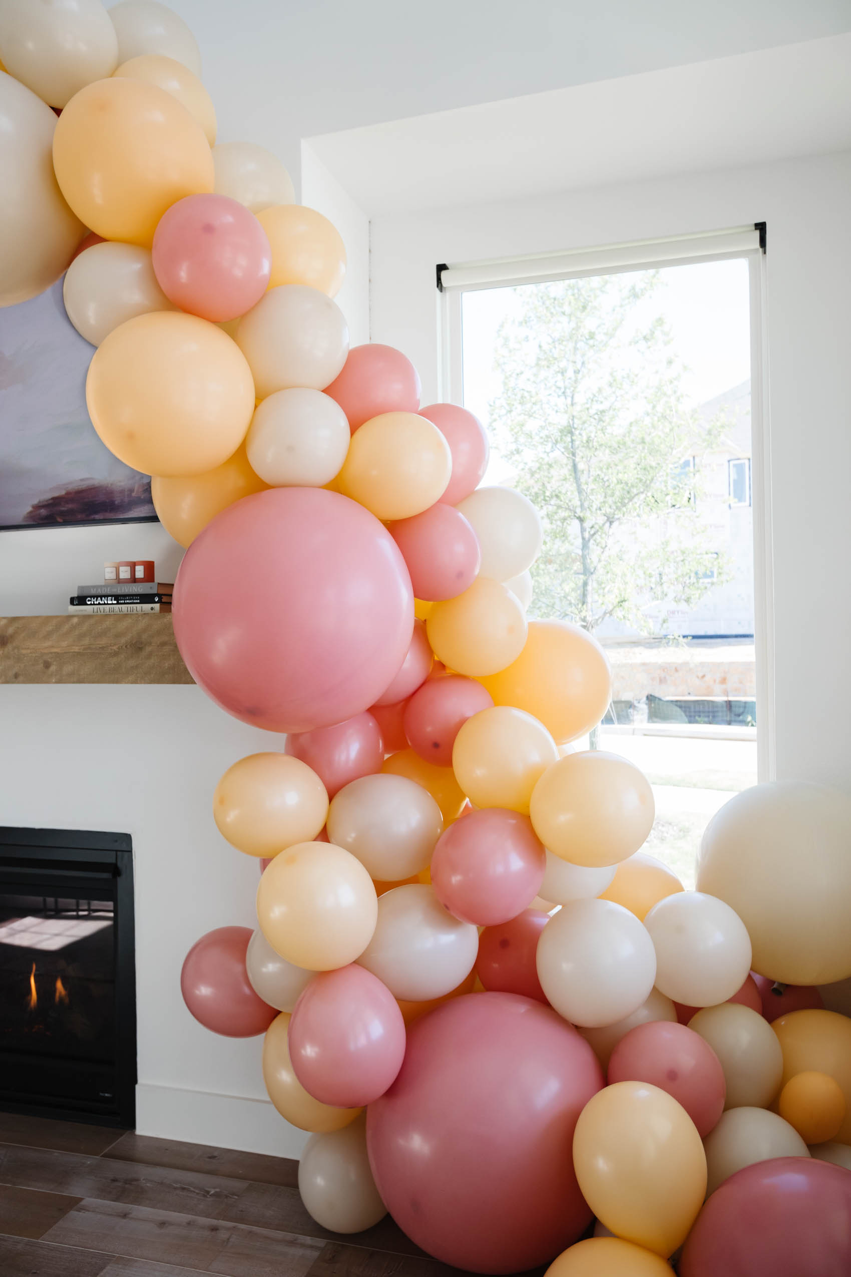 Balloon garland with a chunky bottom in blush, mauve, and nude by Lushra in a Dallas home