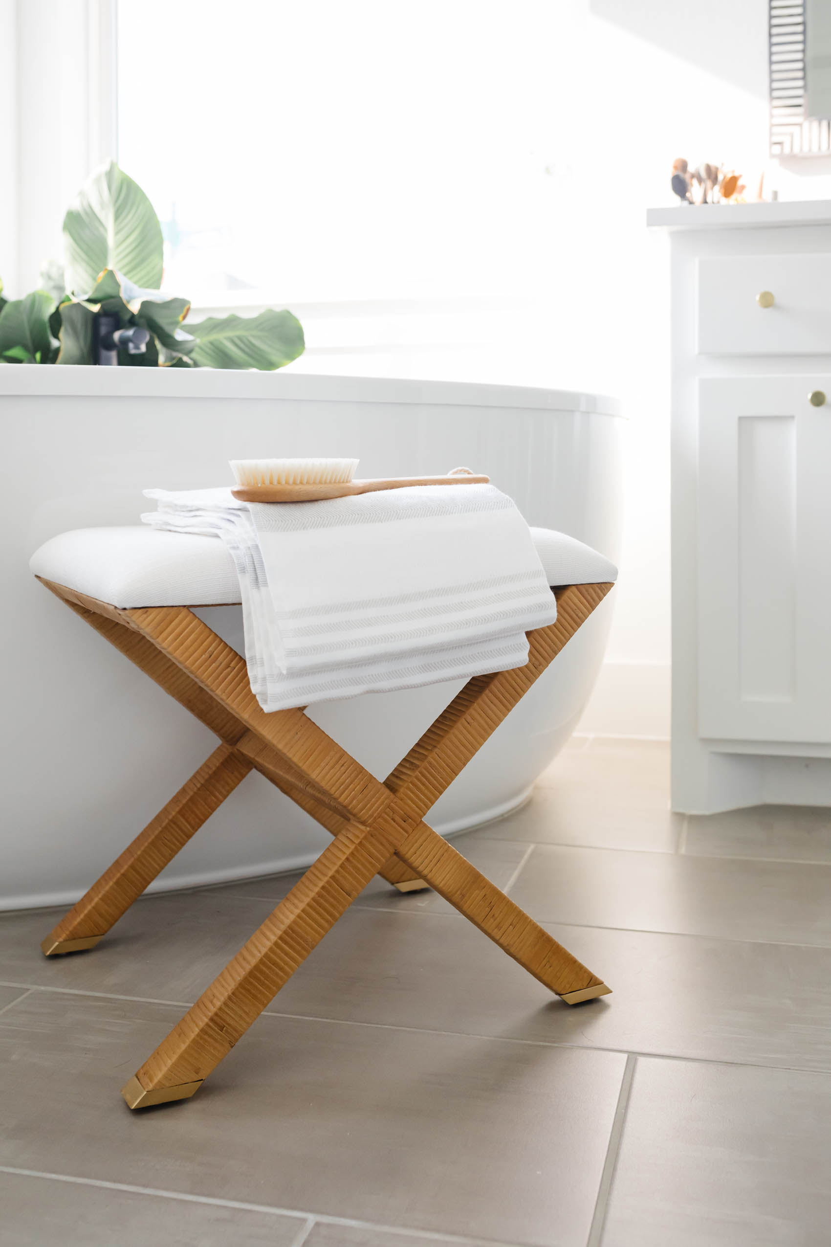 Serena & Lily Balboa X Base stool with luxury bathroom accessories in a white transitional bathroom