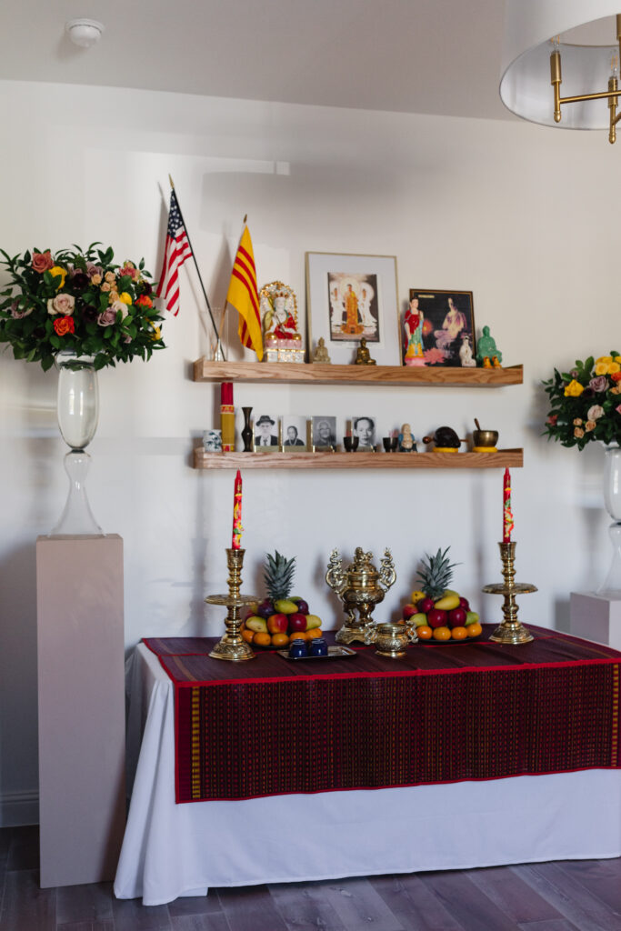 A Buddhist altar with photos of ancestors at a Dam Hoi, a Vietnamese Engagement Party also known as Le Dinh Hon with florals by Something Pretty Floral