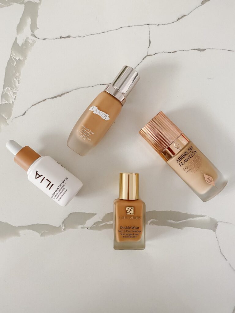 blogger hoang-kim cung shares the 10 best foundations including charlotte tilbury airbrush flawless foundation, estee lauder double wear stay-in-place foundation, la mer the soft fluid long wear foundation, and ilia super serum skin tint spf 40