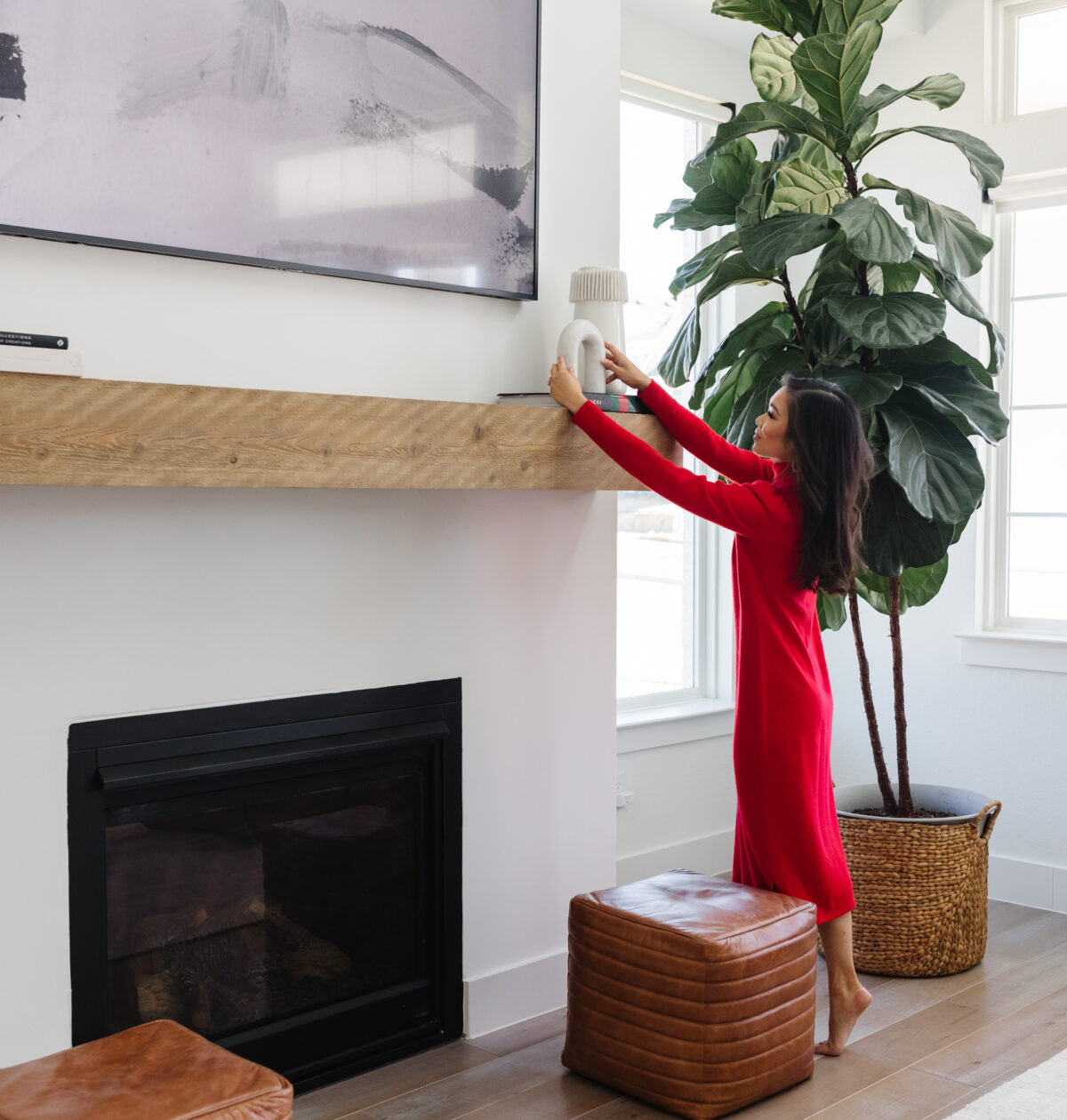 Blogger Hoang-Kim Cung's living room in her transitional style home with a fiddle leaf fig, Samsung Frame TV, and Arhaus leather poufs