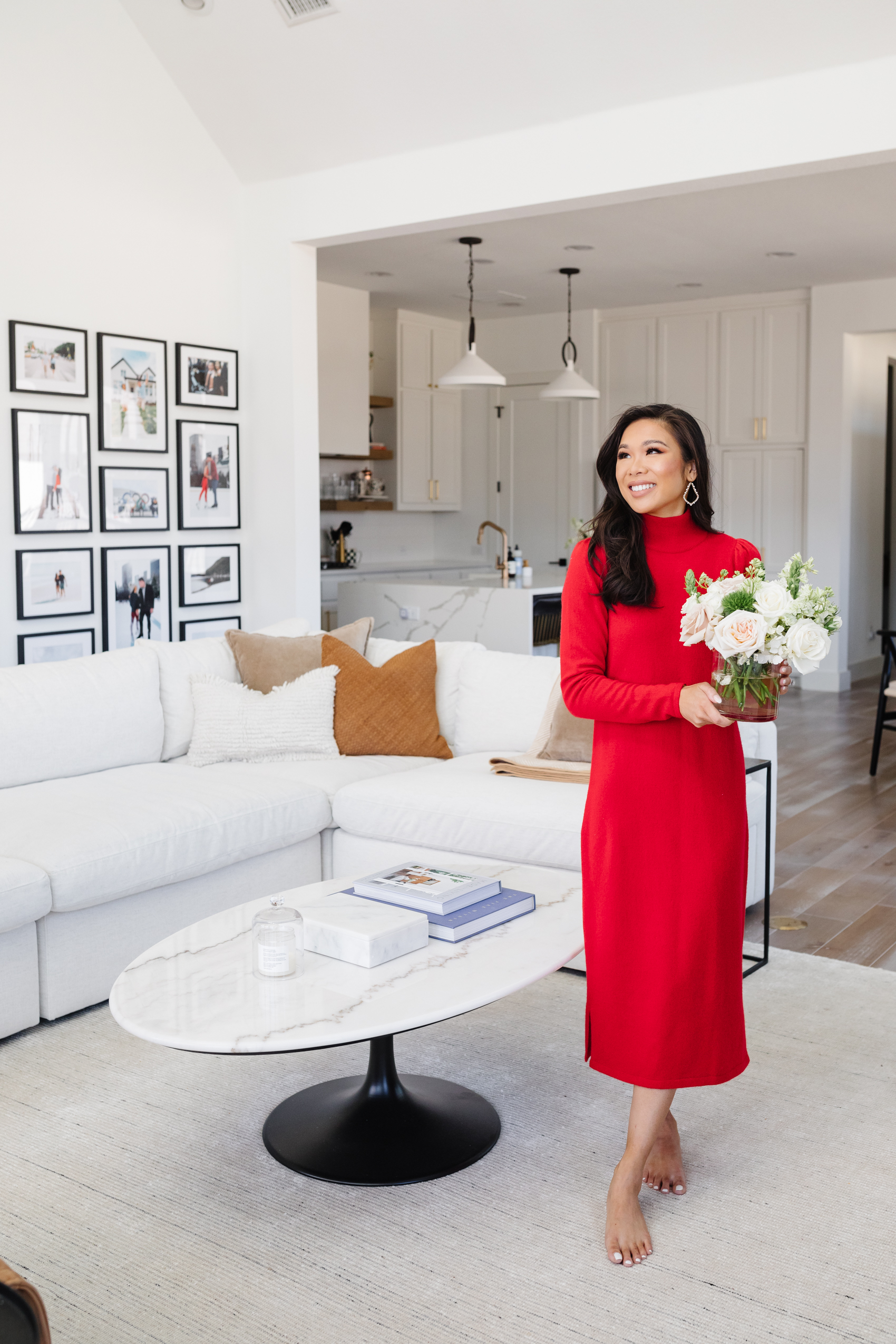 Blogger Hoang-Kim Cung's living room in her transitional style home with a Framebridge gallery wall, Arhaus white sofa, and Arhaus marble coffee table