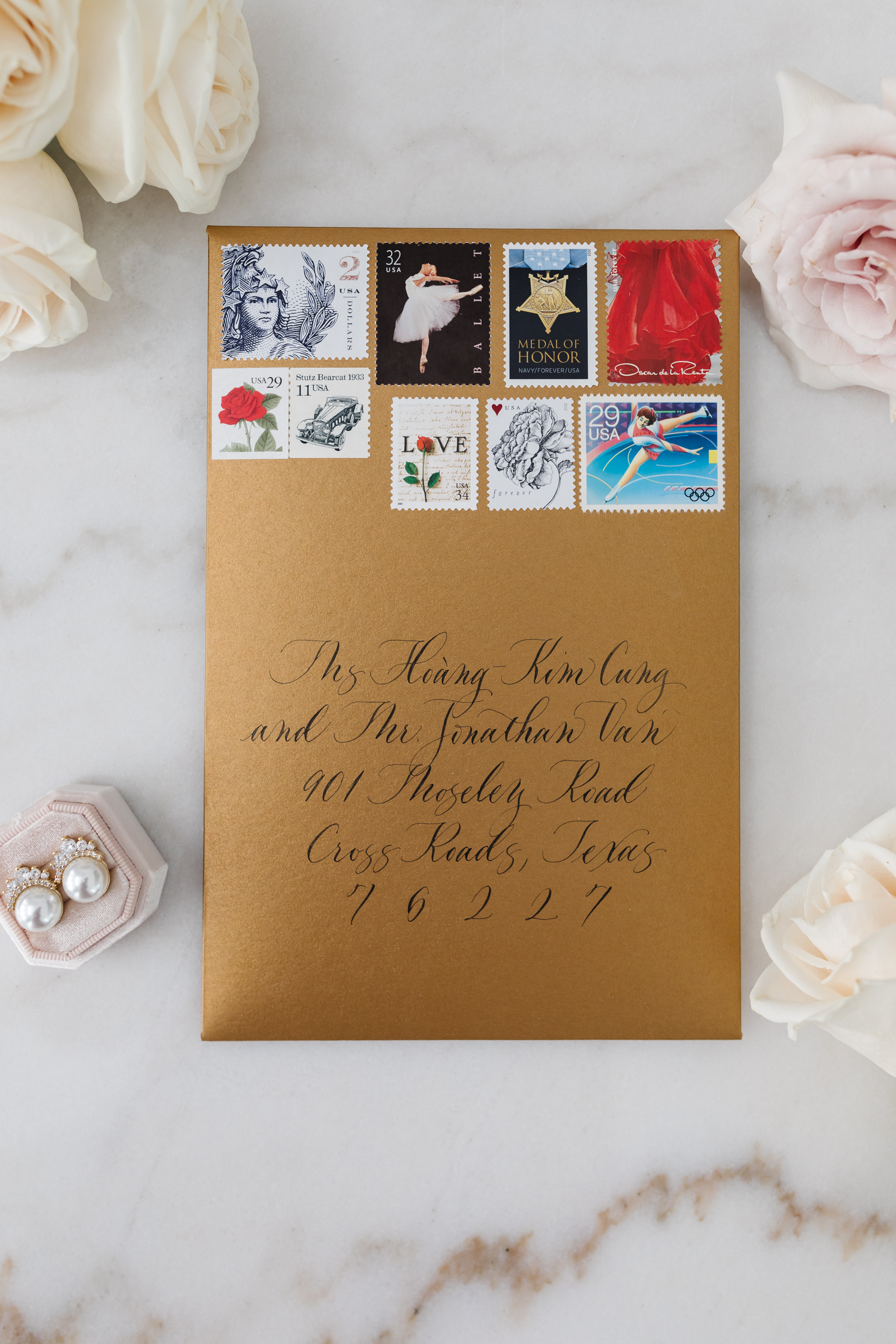 Blogger Hoang-Kim Cung's custom wedding invitations with gold envelopes, calligraphy, and curated stamps