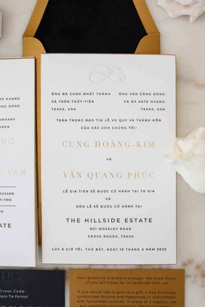 Blogger Hoang-Kim Cung's custom wedding invitations in vietnamese featuring gold beveled edges and letterpressed words with gold envelopes and black envelope liners