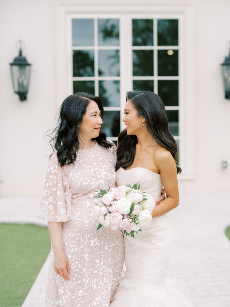 Hoang-Kim Cung wearing a Vera Wang Gemma gown with her Maid of Honor wearing a Needle & Thread Sequin Ribbon gown at a Dallas outdoor wedding