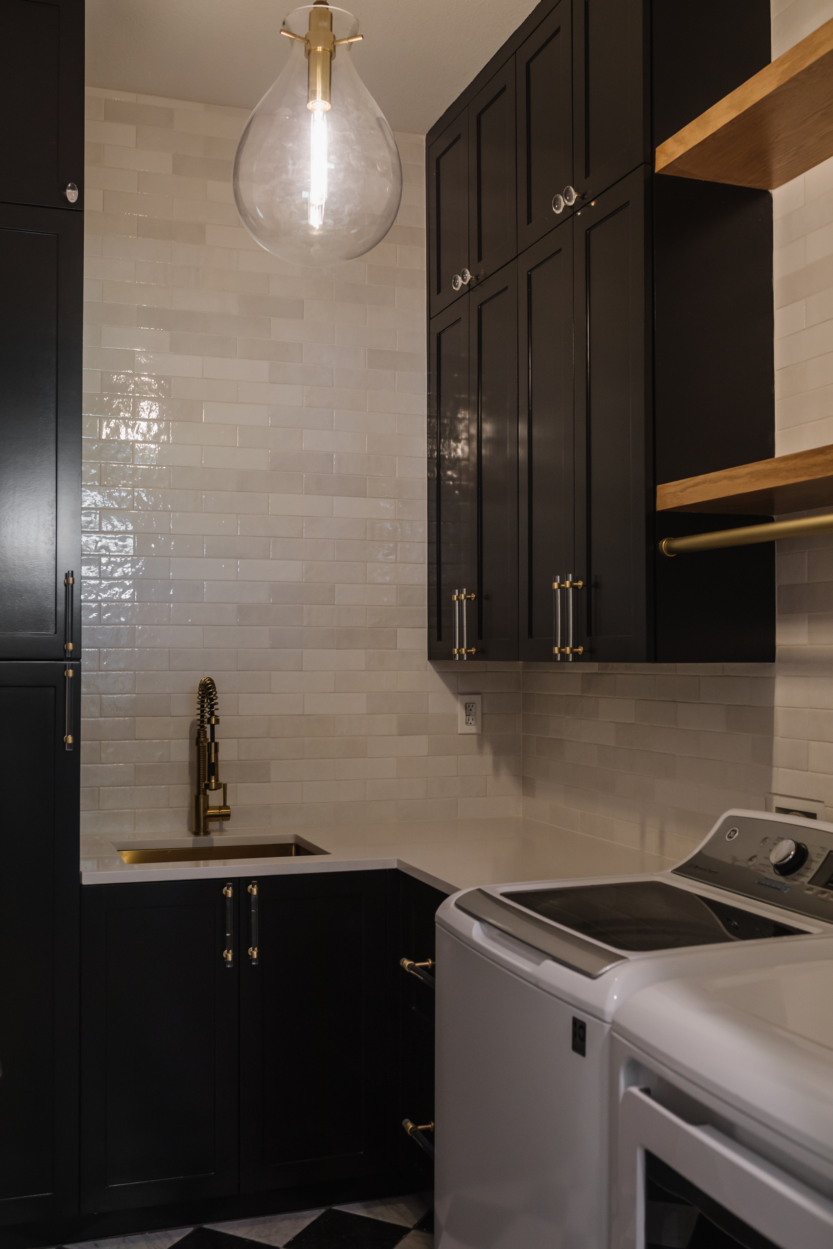 Alexander James Tile Studio Handcraft white subway tile backsplash with cabinets painted Sherwin Williams Tricorn Black with a Hudson Valley Ivy Pendant