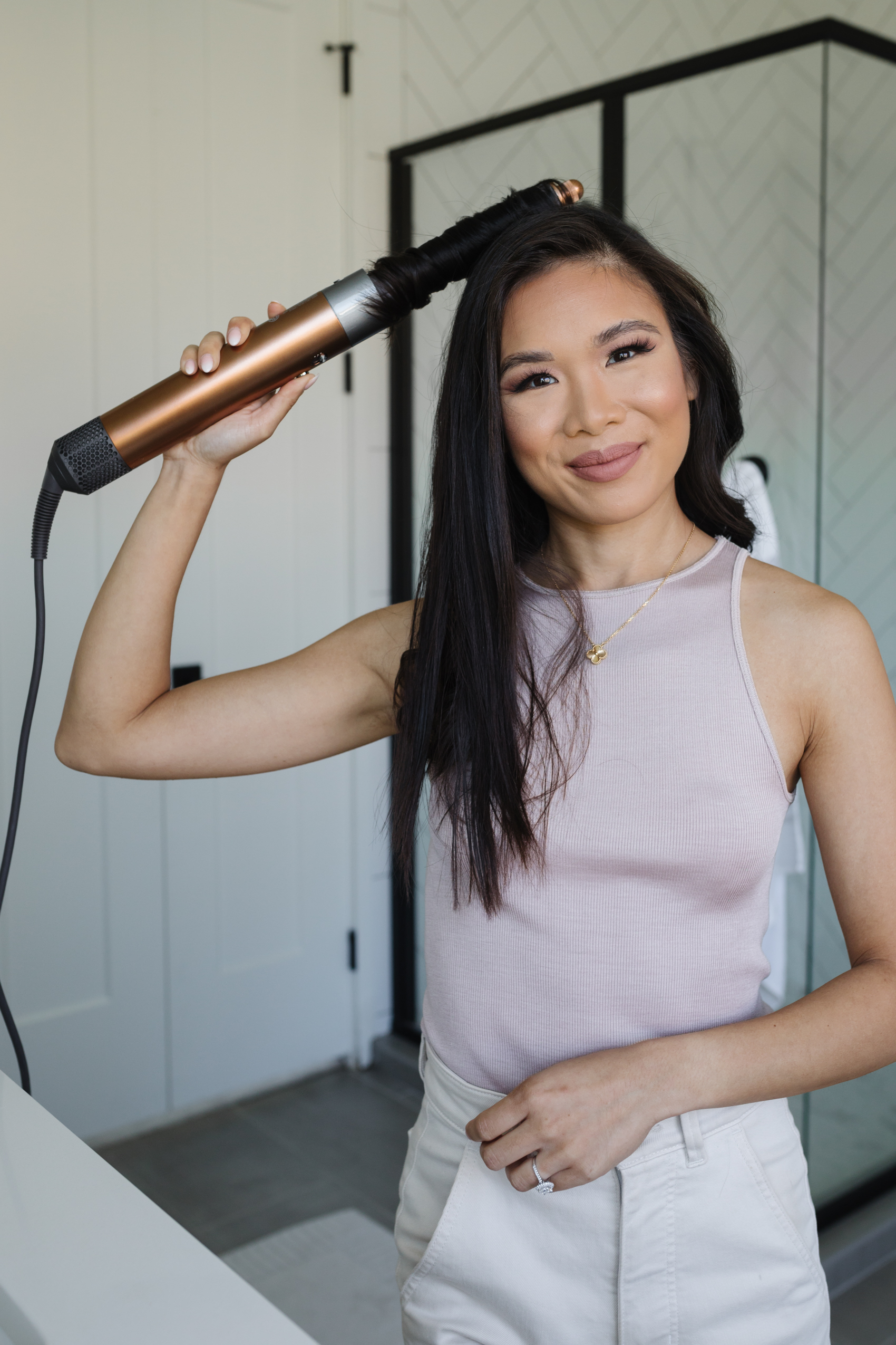 Blogger Hoang-Kim using the new Dyson Air Wrap in copper and nickel with barrels that go in both directions.