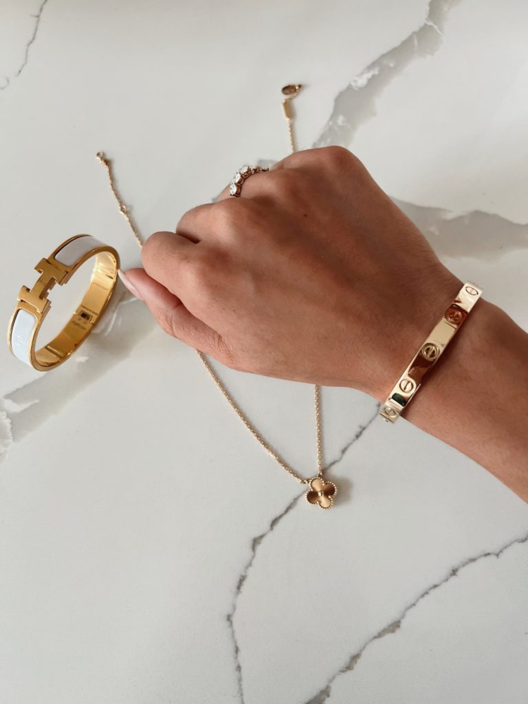 blogger hoang-kim cung's luxury jewelry including Van Cleef & Arpels Vintage Alhambra Pendant Necklace, Cartier Love Bracelet, and Hermes Clic Clac H Bracelet