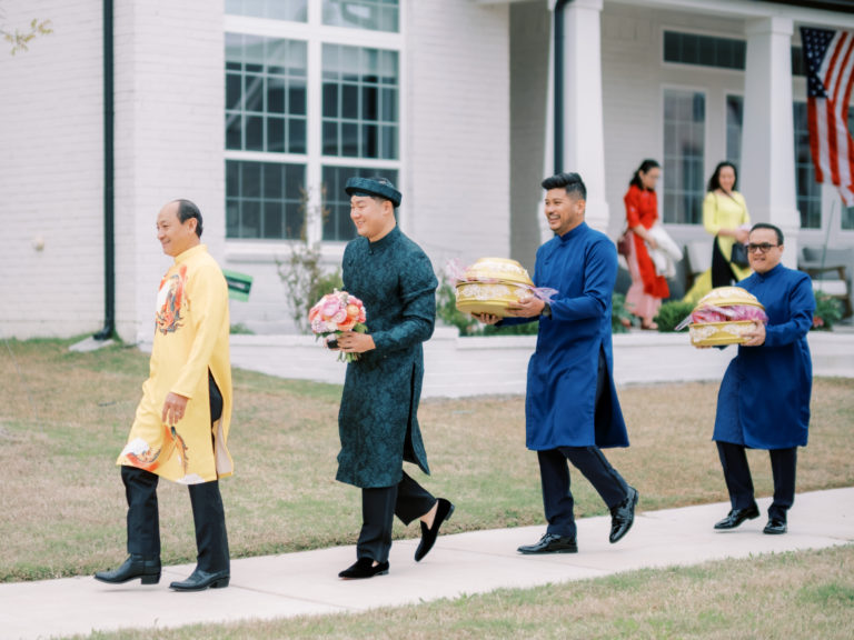 Jonathan Van and his groomsmen carrying mam qua during the processional as part of Vietnamese Wedding Traditions.