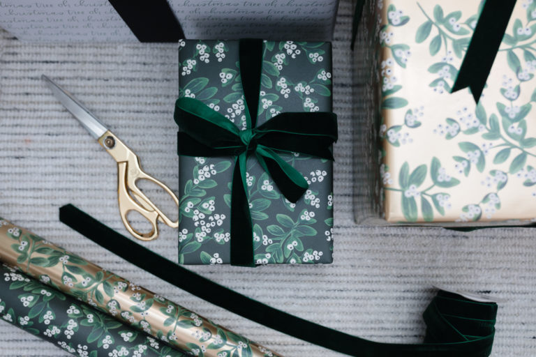 blogger hoang-kim cung shares how to wrap a gift with evergreen mistletoe wrapping sheets by rifle paper co