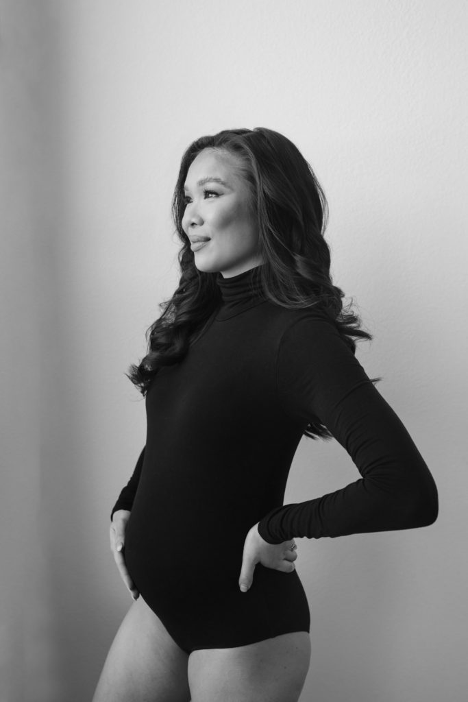 Blogger Hoang-Kim wearing a maternity bodysuit during her second trimester for bump progress photos.