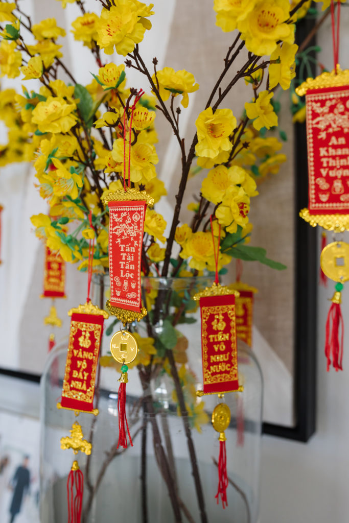 yellow blossoms, small banners and silk lanterns lunar new year decor