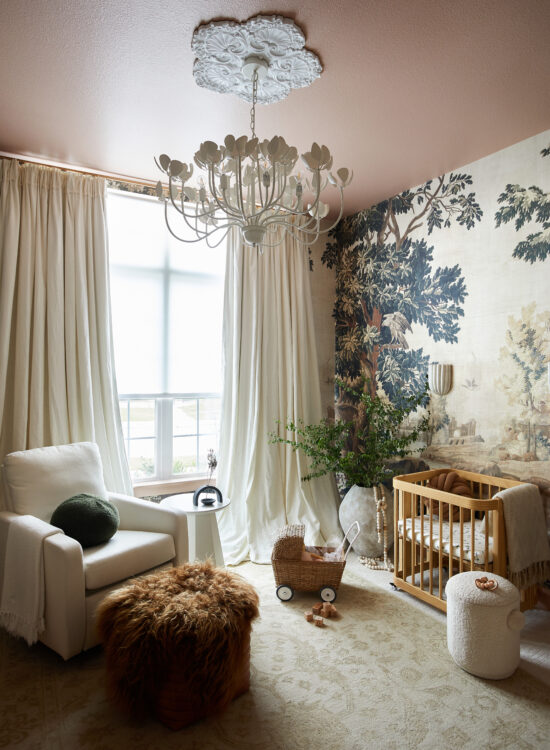 Nursery design for a girl by Urbanology Designs featuring KEK Amsterdam wallpaper, oilo glider, Nestig crib, balloon drapery and floral chandelier.