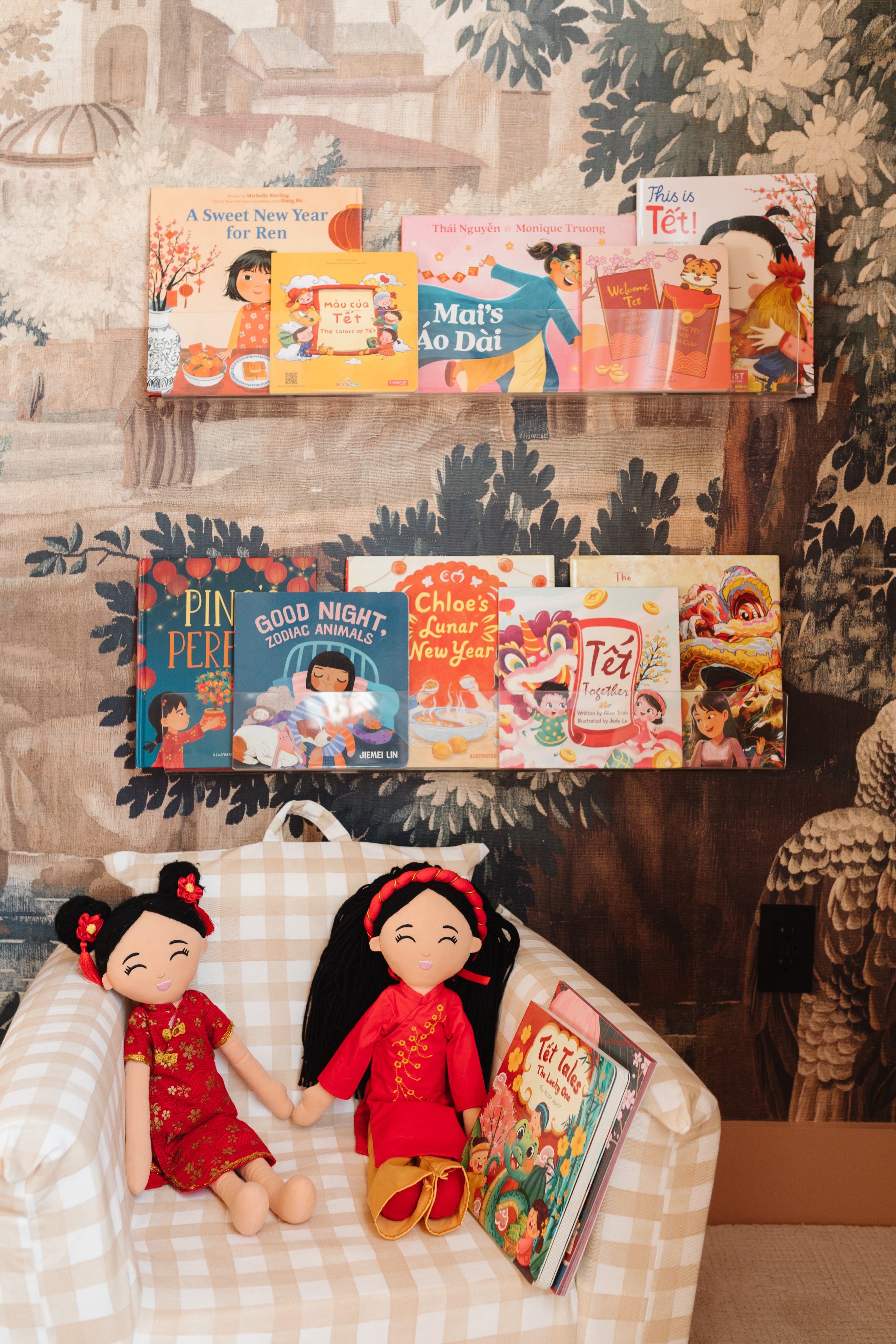 Lunar New Year books our toddler loves reading on her clear bookshelf in her room with JoeyDolls Asian Cultural dolls.